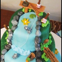 Fishing Scene Made this for my dad's retirement party. I wish I was good with sculpting I would have tried to make my dad actually fishing, but oh...