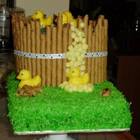 Duckies Tub Cake Everything is edible except the ribbon. Tub is chocolate/mocha layers, bottom is lemon/lemon curd/with coconut grass. The duckies are lemon...
