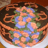 Birthday Cake 10 inch round 2 layer Chocolate BC Frosting w/royal icing pansies. 1 vanilla layer and 1 chocolate layer cake.