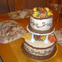 Class Level 3 Final Cake Buttercream frosting w/royal icing lilies and petunia flowers, butterflies are made out of royal icing. Luster dust on the flowers and...