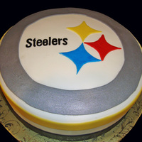 Pittsburgh Steelers Logo Cake Chocolate cake filled and coated in chocolate ganache, then covered in fondant.
