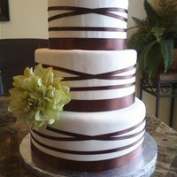 Bridal Luncheon 3 tiers french vanilla with french vanilla mouse filling covered in vanilla fondant. chocolate brown satin ribbon with sage flower.