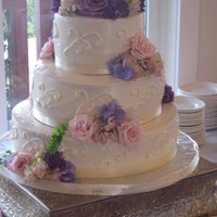 White Wedding Cake With Fresh Flowers 3 tier white buttercream cake with scroll design and fresh flowers cascading downwww.sugarnspicepatisserie.com