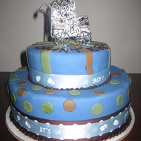 Blue & Brown Boy Baby Shower This is a 2 tier blue and brown baby shower cake for a boy with a silver carriage on top. www.sugarnspicepatisserie.com