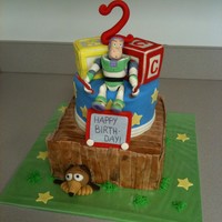 Toy Story Bottom tier is chocolate cake with peanut butter filling, second tier is French vanilla with cappuccino filling and the top two blocks are...