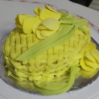 Yellow Tulips On A Basket White cake with yellow buttercream basket weave and yellow gum paste tulips and leaves.
