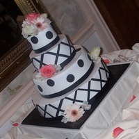 Pauline's Wedding One of the more unique wedding cakes I've ever done...a 4 tier (5, 8, 12, 16 inch) charleston style pound cake covered in ivory...