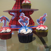 Spiderman Cupcakes Chocolate cupcakes with blue and red webs and Spiderman toppers.