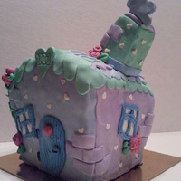 Little Blue And Purple House Little blue and purple house cake with roses and hearts as roof tiles