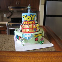 Toy Story Birthday Cake MMF and toys bought for cake. Inspiration from all the toy story cakes I have seen. I made this for my sons 2nd birthday.