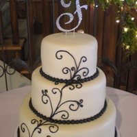 Swirly Swirly Chapagna colored fondant with pipped black detailing. I eventually put red roses on it, but I forgot to snap a picture! This will have to...