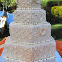 Ivory Hexagon Cake I loved making this cake. The bride chose ivory fondant with ivory details. The large flowers were made with my cricut and the small...
