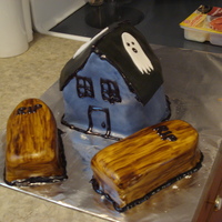 Haunted Cottage Cake The cottage is a spice cake with cream cheese icing and fondant! It is 100% edible. The coffins are handpainted and are also spice cake...
