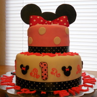 Minnie Mouse Cake Yellow cake with buttercream and marshmallow fondant! Gum paste ears and minnie heads. 1 year birthday cake!