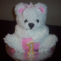 First Birthday Teddy Bear White teddy bear with pink detail. White cake with buttercream frosting. Made with the stand up bear pan from Wilton