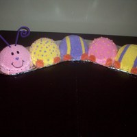 Crawling Towards Your First Birthday! Catepillar cake for a first birthday. White cake with buttercream frosting.