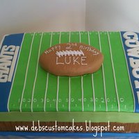 Football Field Giants vs Cowboys! Vanilla sponge cake with chocolate buttercream filling. Cake is covered in vanilla buttercream with fondant details. The...
