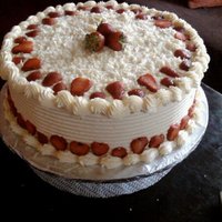 White Chocolate Gateaux white chocolate ganache with sliced strawberries and white chocolate curls