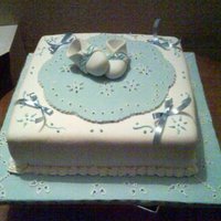 Baby Shower Cake Coconut cake with white and blue fondant.Bootees are gumpaste, Ribbons are satin.