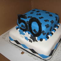 50Th Birthday Two Tier white velvet cake with raspberry filling. Covered with fondant, with fondant diamond cutouts, numbers and stars.