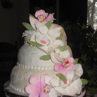 Pink Orchids I made this cake just for practice. It's a yellow cake with buttercream frosting and filling, covered in fondant with gumpaste flowers...