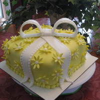 Yellow Daisy Cake With Bow This is a White Velvet cake with raspberry filling covered in fondant with fondant daisies and bow.