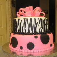 Zebra Stipes Bottom tier is yellow cake with buttercream filling covered in pink fondant with black polka dots. Top tier is chocolate with buttercream...