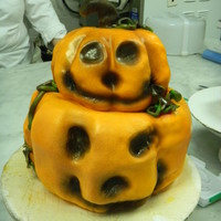 Jack O'lantern Cake Pumpkin carved from cake layers and covered with fondant