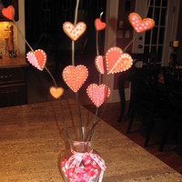 Vaentine's Day Cookie Vase Gingerbread cookies with color flow icing attached to branches with royal icing and placed in a vase with ribbin and m n m's!