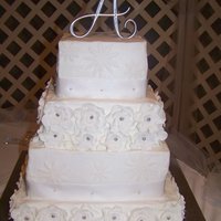 Wedding Cake I made this for my friends wedding. She found the idea for the cake here on cakecentrl. All buttercream, with fondant flowers.