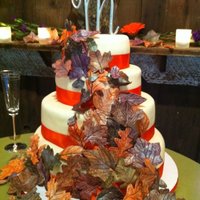Fall Themed Wedding Cake four tiers, 2 each of banana/choc buttercream and champagne/strawberry buttercream. Rolled buttercream fondant, satin ribbon and gumpaste...