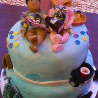 Engagement Cake Banana cake/choc buttercream and root beer cake/vanilla buttercream. Fondant gumpaste decorations depicting things couple specified.