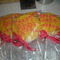 Softball Cookies Party favors at a softball birthday party. Each party goer's name was written on their softball cookie pop. Yellow buttercream and red...