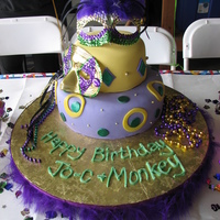 Mardi Gras Made for a Mardi Gras theme. I wish I had gotten a better picture. 6" & 10". Hand made mask cake toppers. Fondant cake w/...