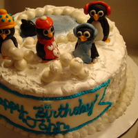 Penguins Chocolate cake with Buttercream, filled with strawberry filling and chocolate ganache. Penguins are fondant.