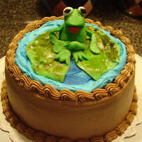 Frog Cake Chocolate cake with oreo filling, covered in buttercream. Frog and lilly pad is fondant.