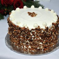 Red Velvet Cake This cake was for a friend's Christmas Party. Red Velvet layers with Whipped Cream Cheese Frosting and pecans. She is a photographer...
