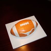 Ut Football cake shaped into a football and covered in fondant