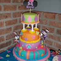 Club House Minnie Mouse This is a four tier chocolate with raspberry cake covered with MMF. The decorations are MMF too.