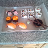 Sushi My friend made a sushi boat and asked me to make the sushi to go on top. Everything made of fondant. I rolled in in coconut for the rice...