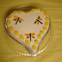 Heart A Flutter Heart cake covered with white fondant. Painted (with icing gel and clear vanilla extract) on dragonflies. Wings are outlined in yellow...
