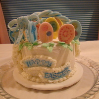Happy Easter 6" x 4" w/BC icing. Fondant for decorations. Stamps and pearl dust used to accent eggs. The bow was imprinted with star end of...