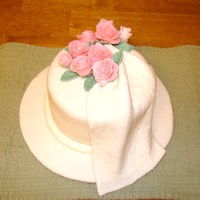 Pink Roses With Floral Imprint Drape 8 x 4 " round cake covered in white fondant, along with board. Floral imprint white fondant and gum paste drape, with pink fondant...