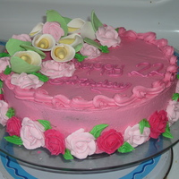 ..... this was just a muck around cake... home made lillies and roses and leaves... it is iced with buttercream, the roses are royal icing and...