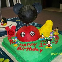 Mickey Mouse Club House i made this for my twin boys first bday. foot is rice krispy treats. everything is ediable except neck is wood support and the toys.