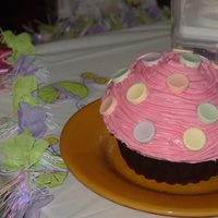 Giant Cupcake First attempt at Wilton's Giant Cupcake. Chocolate Devil's Food cake topped with strawberry frosting and large Sweettarts.