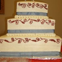 My First Wedding Cake bc iced. blue ribbon on bottom. white piping with red over it