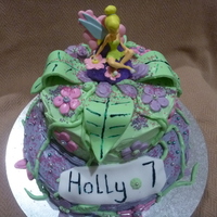 Tinkerbell Cake A 2-tier cake iced with frosting. The leaves, flowers and vines made out of ready-made fondant. I bought Tinkerbell from an online party...
