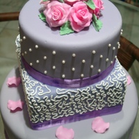 Purple Wedding Cake The first wedding cake I prepared with purple fondant. 2nd tier designed with royal icing and flowers are all made of gum paste.