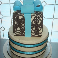 Gift Box Cake This is 2 tier cake with cookes n cream filling. Iced in buttercream, and piping on top tier in bc. Fondant bow.